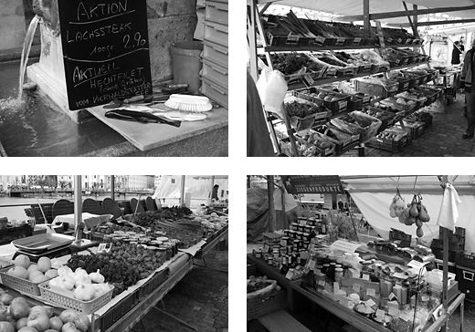 Markt: Gemüsestände, Käsestand, Fischaktionstafel am Brunnen